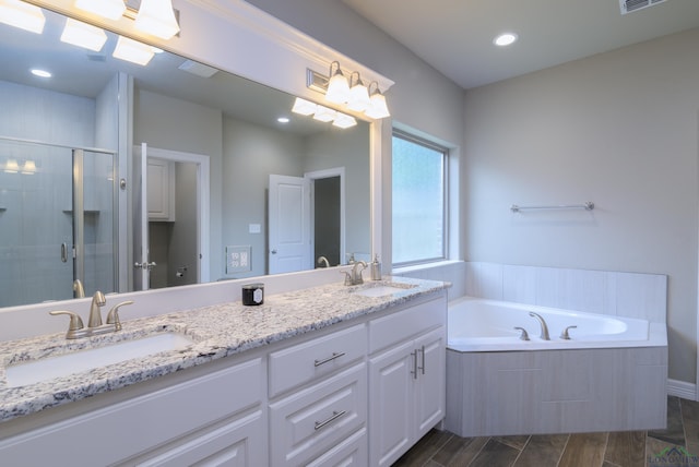 bathroom featuring independent shower and bath and vanity