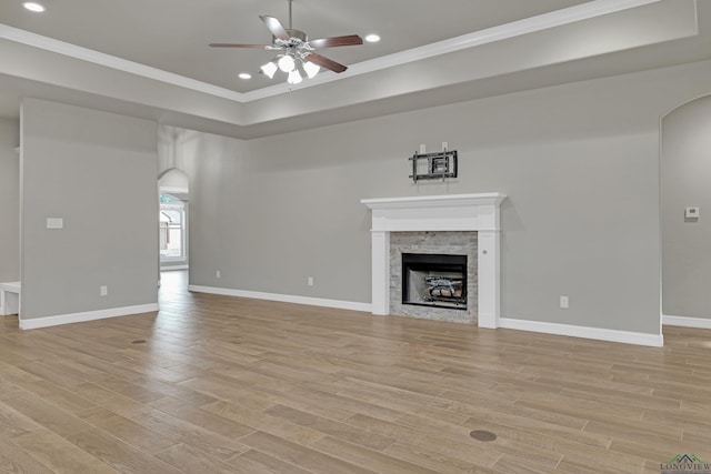 unfurnished living room featuring crown molding, light hardwood / wood-style floors, and ceiling fan