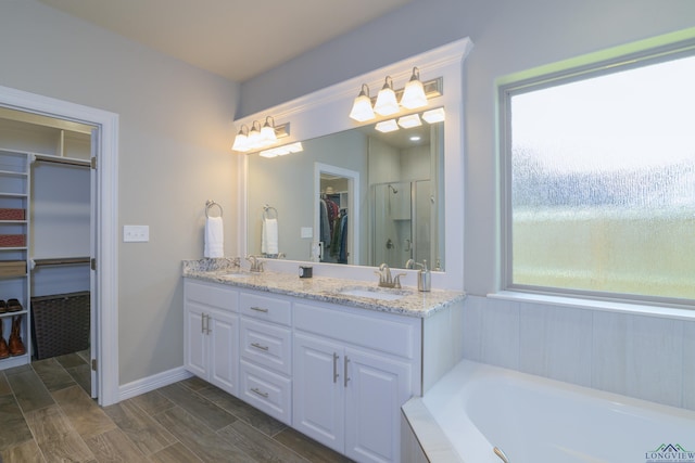 bathroom with vanity, an enclosed shower, and wood-type flooring