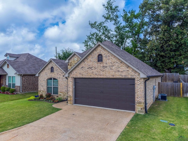 view of front of house with a garage, central AC unit, and a front lawn