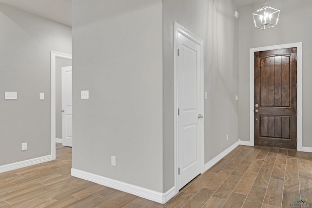 foyer featuring hardwood / wood-style flooring and a notable chandelier