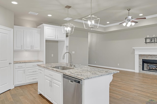 kitchen featuring sink, white cabinetry, dishwasher, an island with sink, and light stone countertops