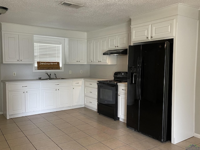 kitchen featuring white cabinetry, sink, a textured ceiling, light tile patterned floors, and black appliances