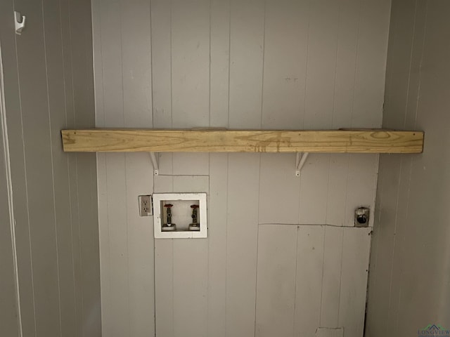 clothes washing area featuring electric dryer hookup, wooden walls, and washer hookup