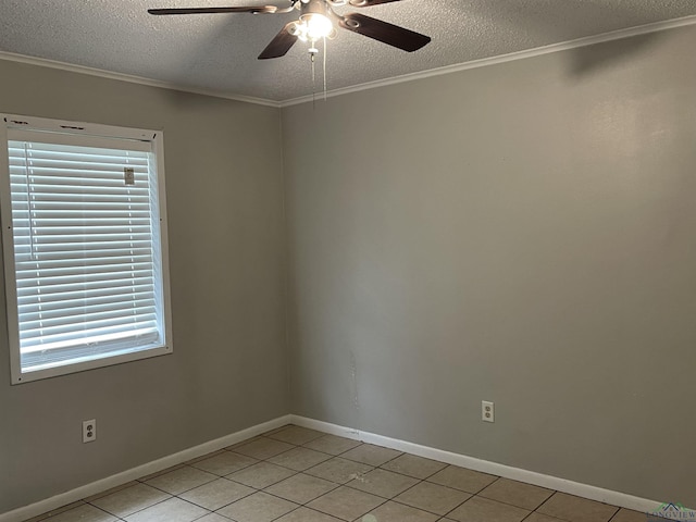 tiled spare room featuring ceiling fan, a textured ceiling, and ornamental molding