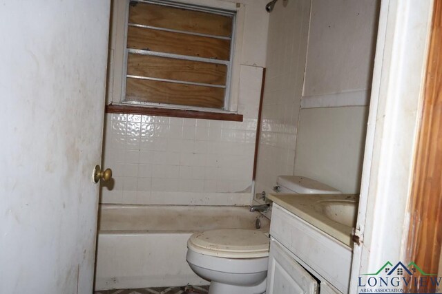 bathroom featuring a bath, vanity, and toilet