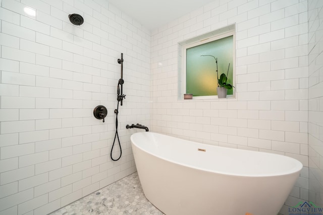 bathroom with separate shower and tub and tile walls