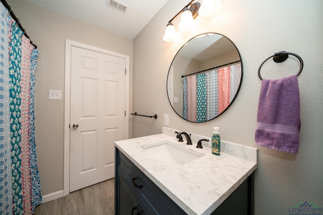 bathroom with vanity and hardwood / wood-style flooring