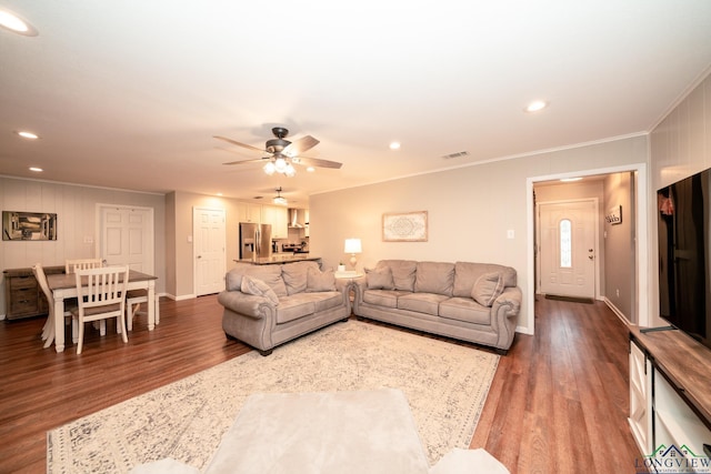 living room featuring wood-type flooring, ceiling fan, and ornamental molding