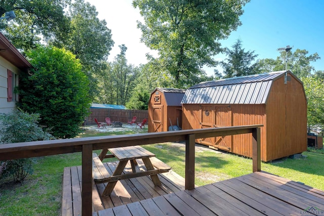 wooden deck featuring a yard and a shed