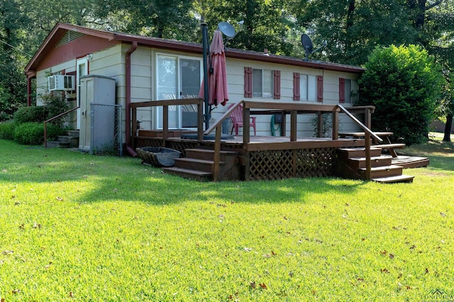 back of house featuring a yard and a wooden deck