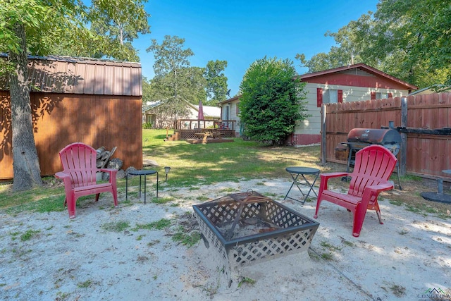 view of yard with a fire pit and a deck