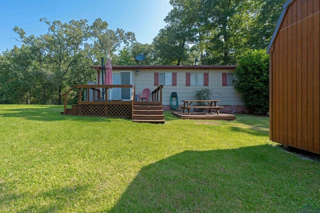 back of property with a wooden deck and a yard