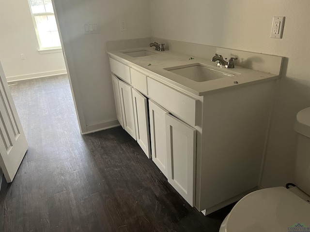 bathroom with vanity, hardwood / wood-style flooring, and toilet