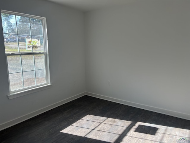 2808 Park Dr, Marshall, TX 75670 - spare room with dark wood-type flooring and baseboards