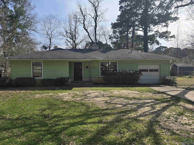 ranch-style house featuring an attached garage, driveway, and a front lawn