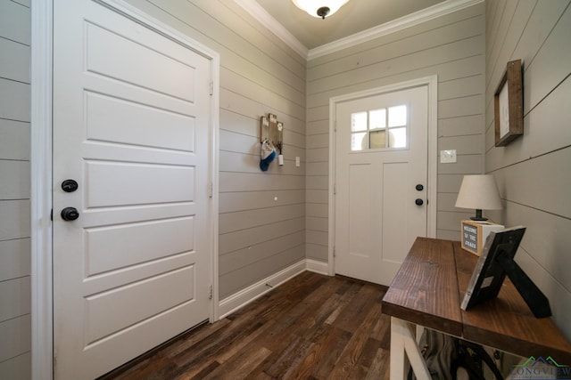 foyer featuring wooden walls, dark hardwood / wood-style floors, and ornamental molding