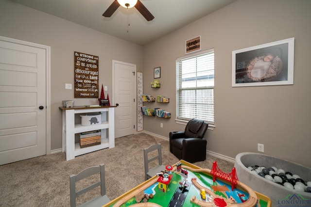 rec room with carpet and ceiling fan