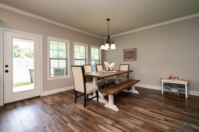 dining area with dark hardwood / wood-style flooring, an inviting chandelier, and crown molding