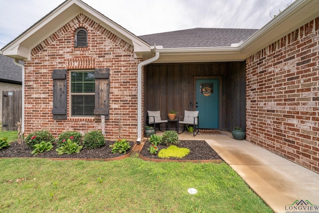 property entrance with a lawn