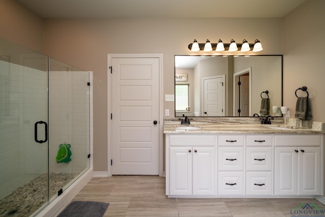 bathroom with tile patterned flooring, vanity, and a shower with shower door