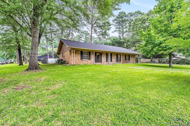 single story home with a front lawn and brick siding