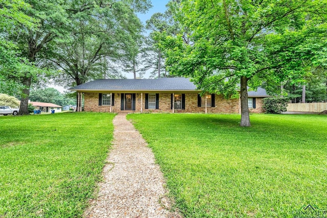 single story home with a front lawn and brick siding