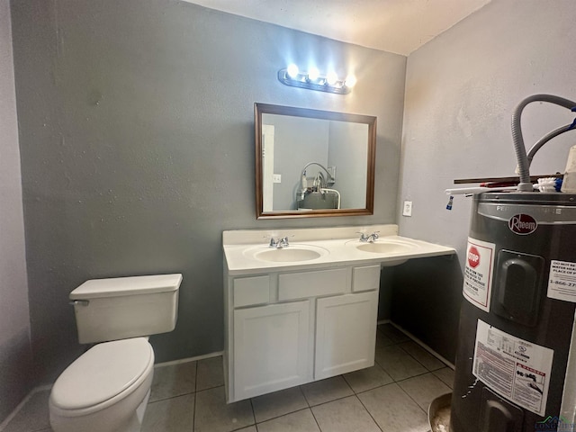 bathroom with tile patterned floors, electric water heater, vanity, and toilet