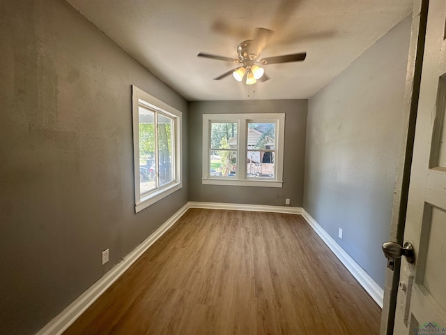 spare room featuring hardwood / wood-style floors and ceiling fan