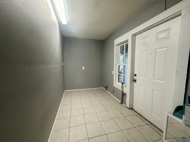 doorway to outside featuring light tile patterned floors