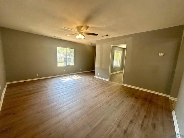 spare room featuring hardwood / wood-style floors and ceiling fan