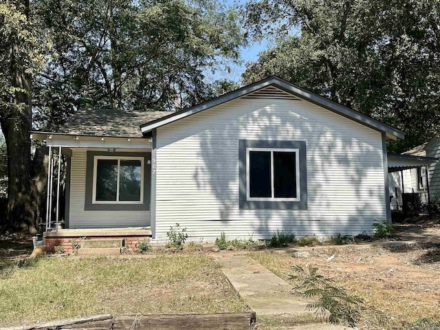 view of side of property featuring covered porch