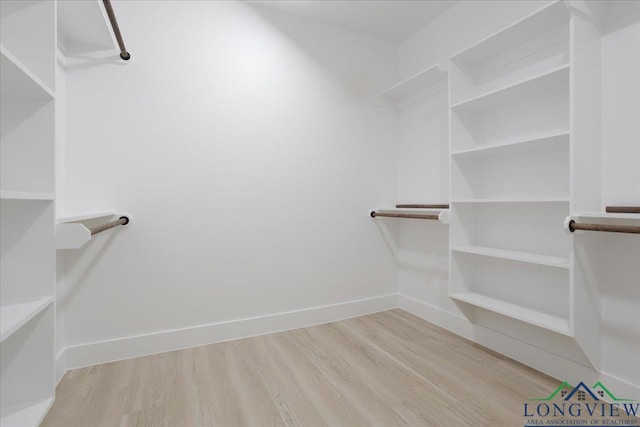 spacious closet with light hardwood / wood-style floors