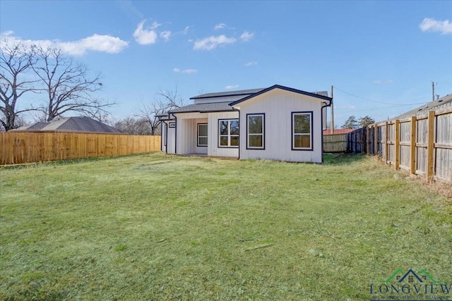 rear view of house with a lawn