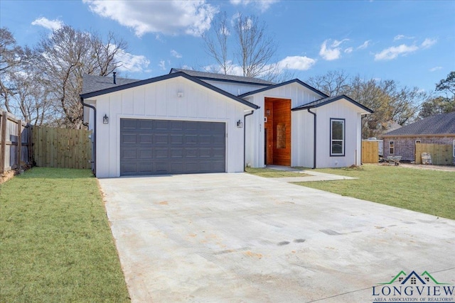 view of front of home with an attached garage, concrete driveway, a front yard, and fence