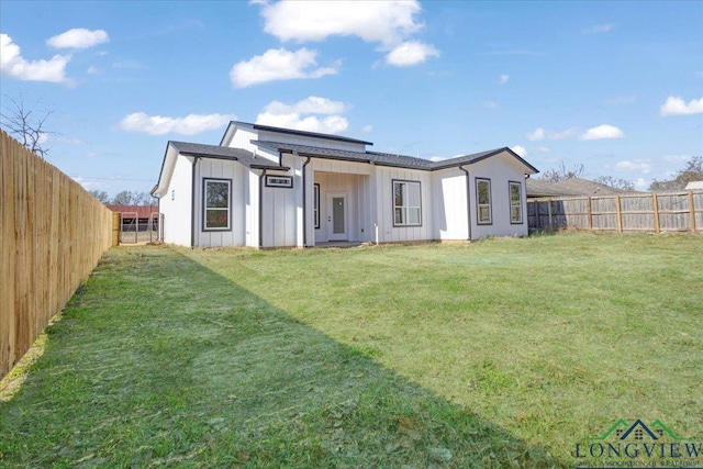 rear view of house with a lawn