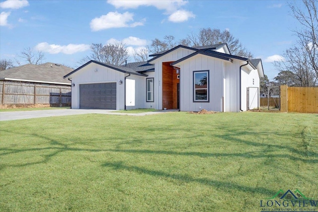 view of front facade with a garage and a front lawn