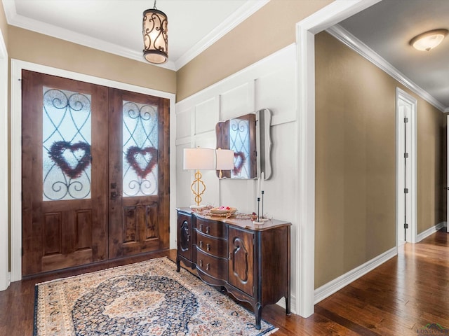 foyer entrance with french doors, ornamental molding, and dark hardwood / wood-style floors