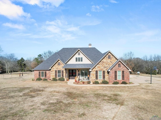 craftsman-style house with covered porch and a front yard