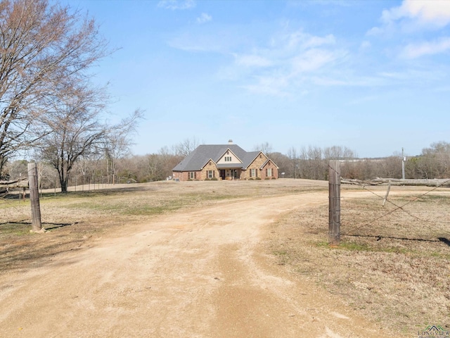 view of front facade featuring a rural view