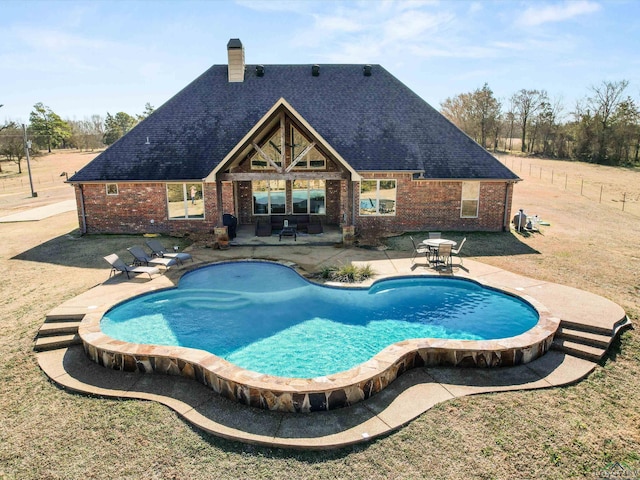 view of pool featuring a patio area and a lawn