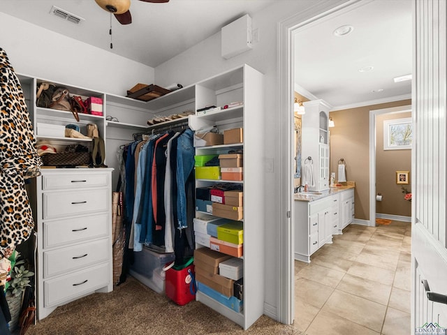 spacious closet featuring light tile patterned floors, sink, and ceiling fan