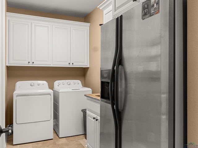 laundry room with cabinets and washer and dryer