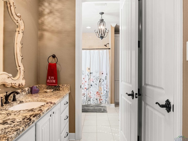 bathroom with a shower with shower curtain, vanity, a chandelier, and tile patterned flooring