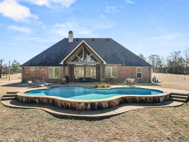 view of swimming pool featuring a patio area and a lawn