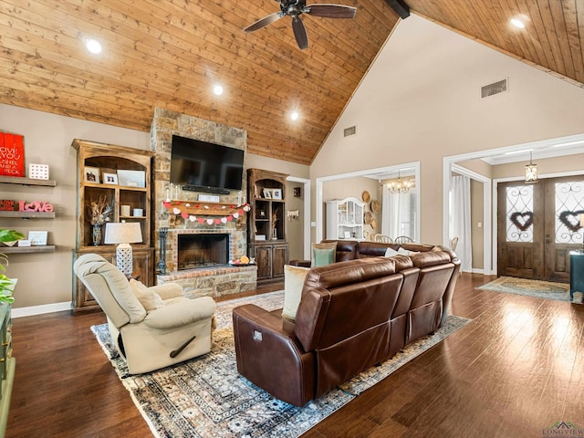 living room with a stone fireplace, ceiling fan with notable chandelier, high vaulted ceiling, dark wood-type flooring, and wooden ceiling