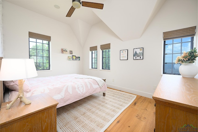 bedroom with vaulted ceiling, light hardwood / wood-style flooring, and ceiling fan