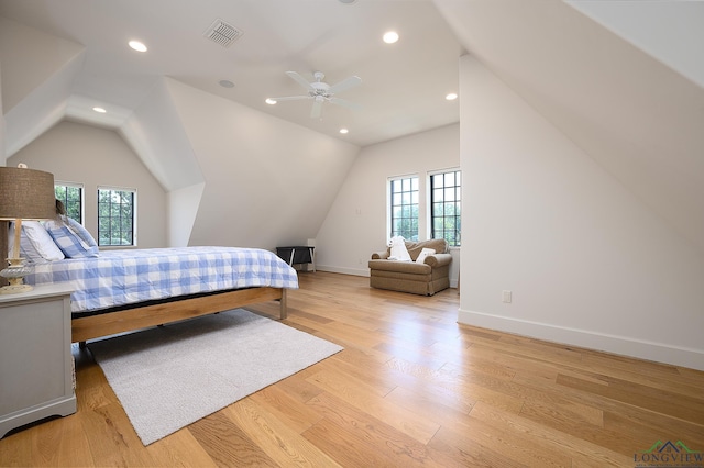 bedroom with light wood-type flooring, vaulted ceiling, and ceiling fan