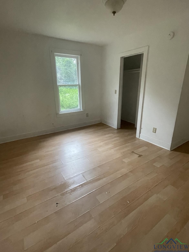 804 High St, Marshall, TX 75670 - empty room with light wood-style flooring and a smoke detector