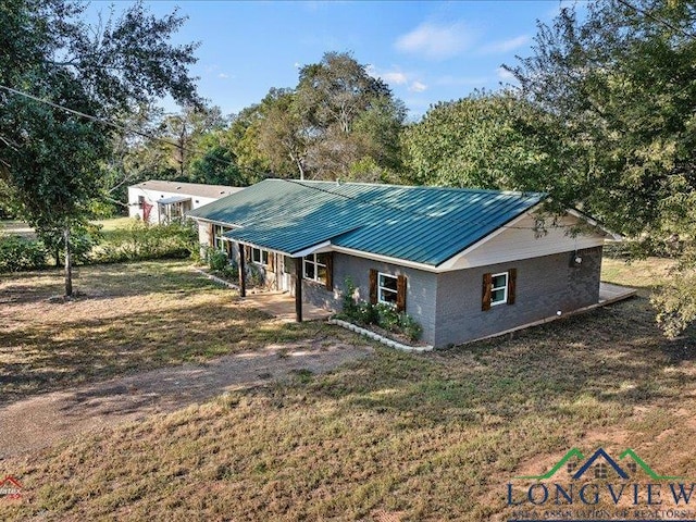 rear view of property with a yard